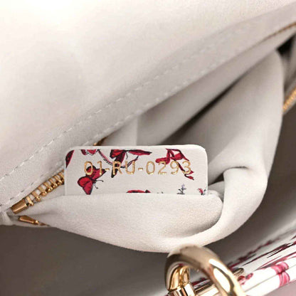 Handbag interior view with floral pocket lining and gold zipper hardware