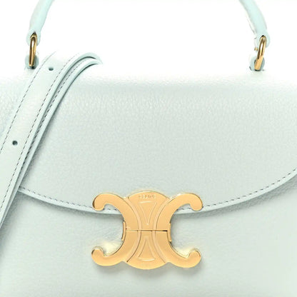 Light blue leather mini bag front with gold logo clasp and top handles