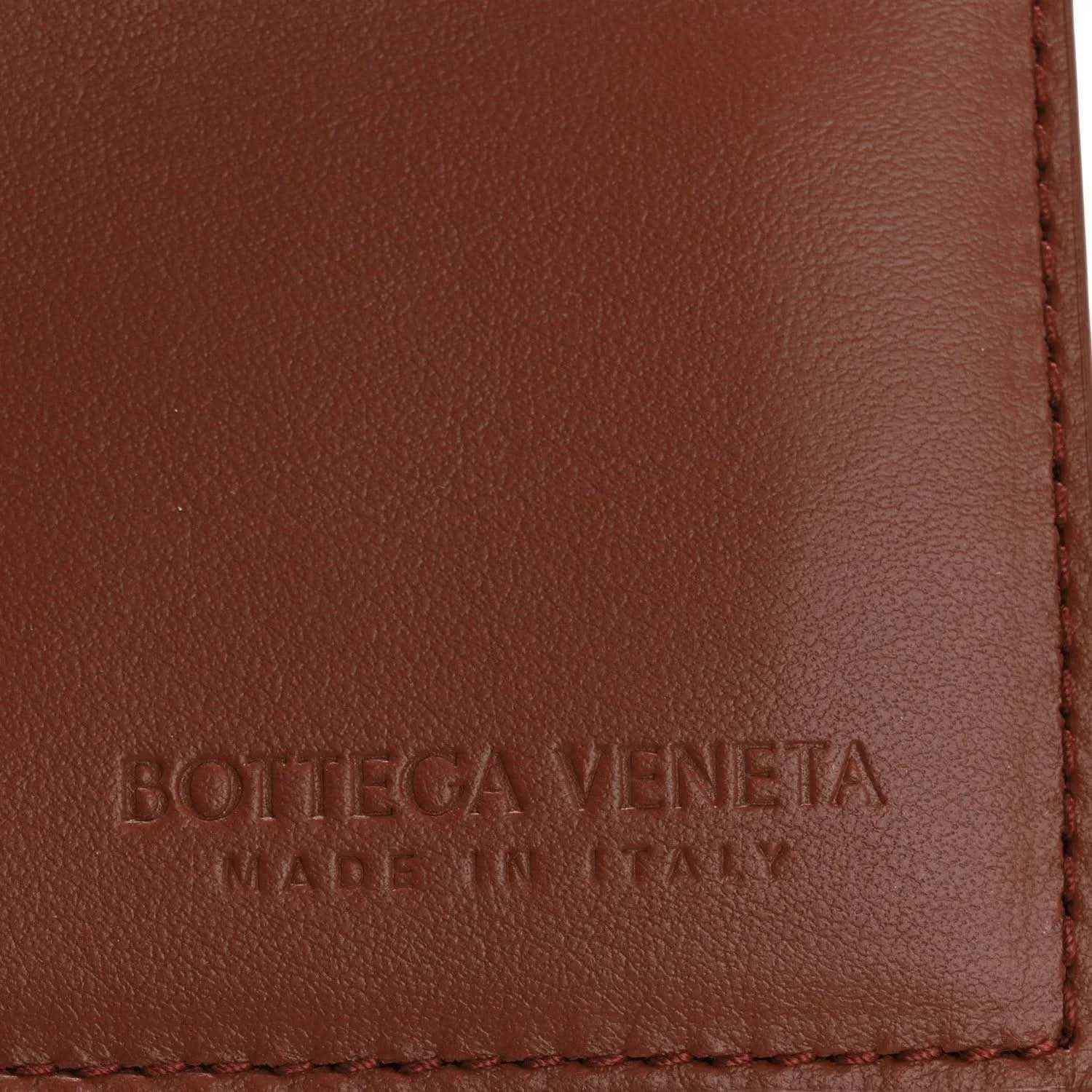 Bottega Veneta stamped leather panel with red-stitched edge on brown flap.