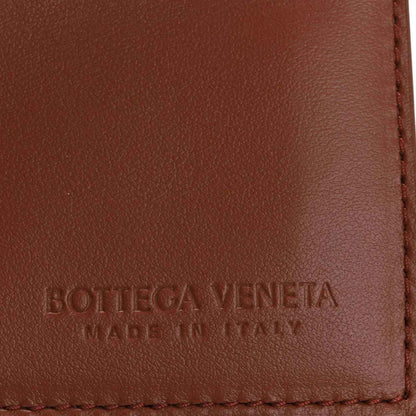 Bottega Veneta stamped leather panel with red-stitched edge on brown flap.