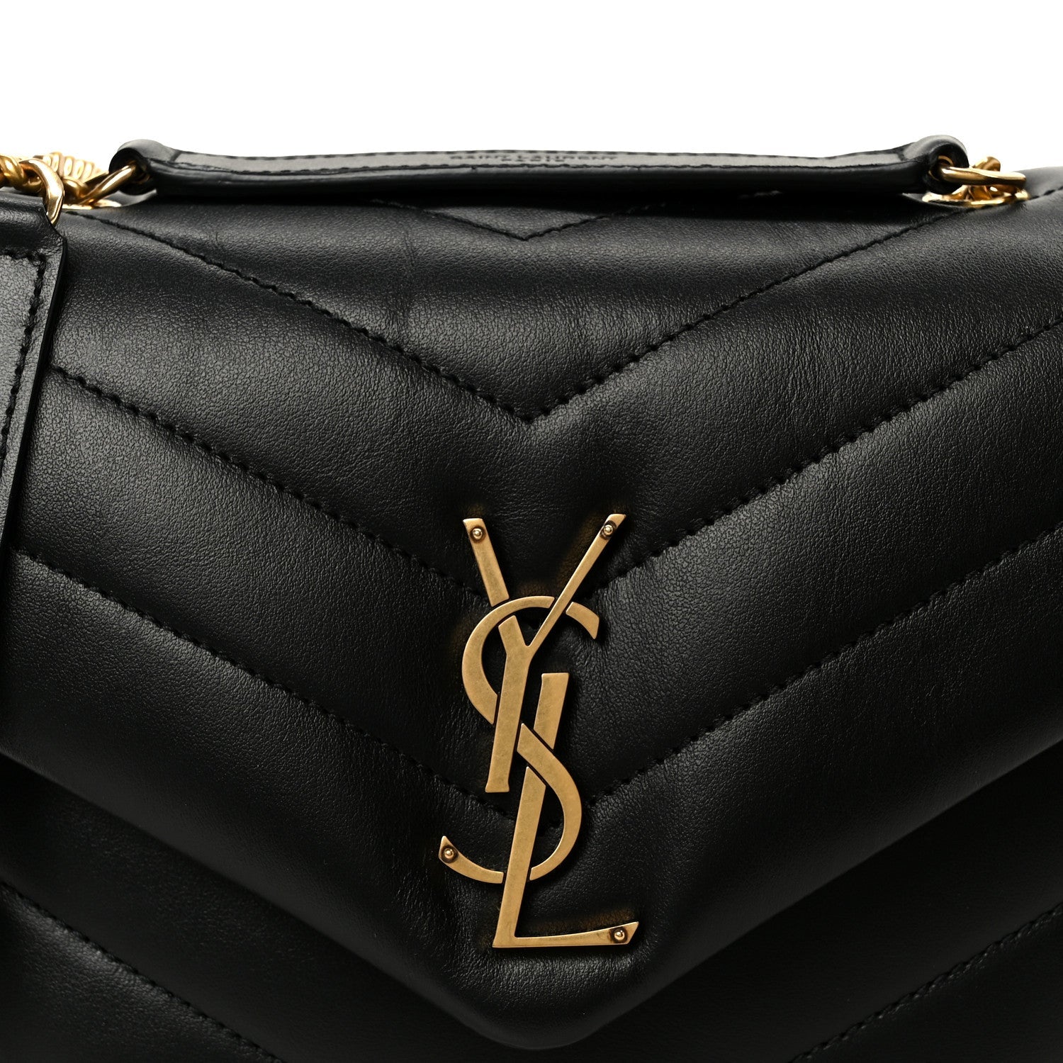 Black quilted leather satchel front with YSL monogram plaque and stitched chevron pattern.