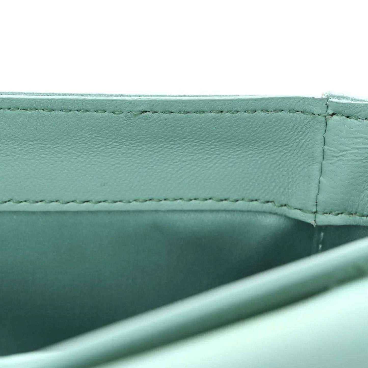 Light blue satin nappa baguette bag, side seam and interior panel close-up