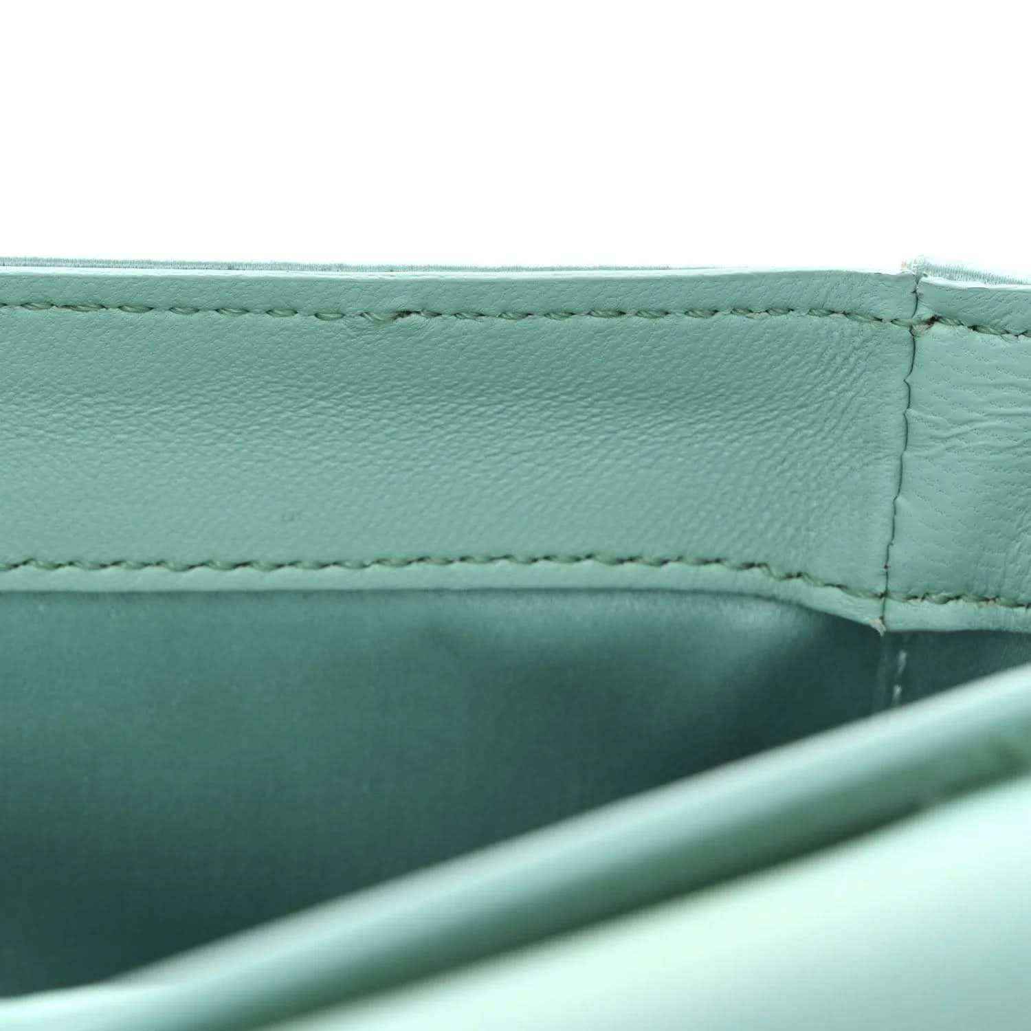 Light blue satin nappa baguette bag, side seam and interior panel close-up