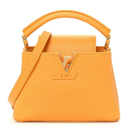 Mini Capucines handbag in yellow textured leather with top handle and gold-tone LV lock