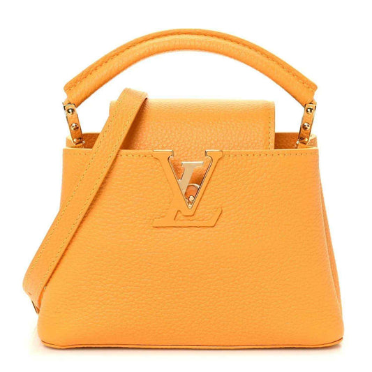 Mini Capucines handbag in yellow textured leather with top handle and gold-tone LV lock