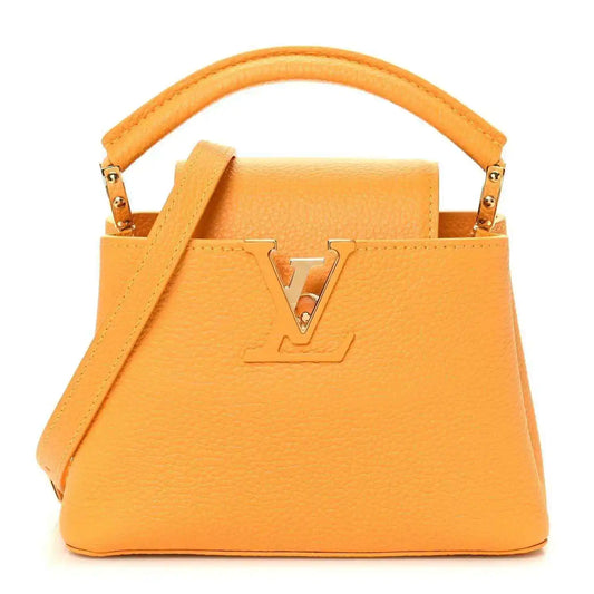 Mini Capucines handbag in yellow textured leather with top handle and gold-tone LV lock