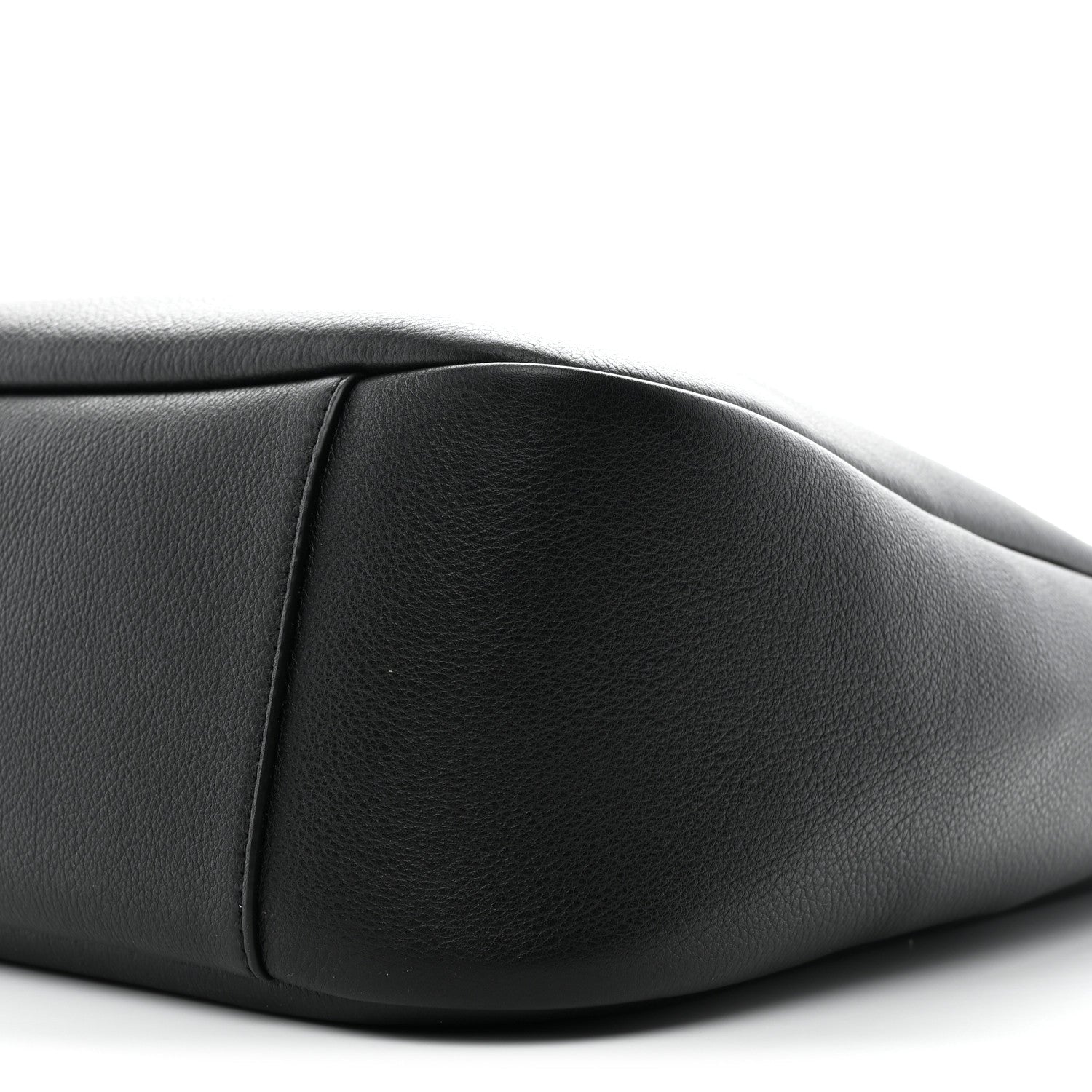 Black calfskin soft hobo bag close-up, showing curved seam and smooth texture