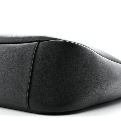 Black calfskin soft hobo bag close-up, showing curved seam and smooth texture