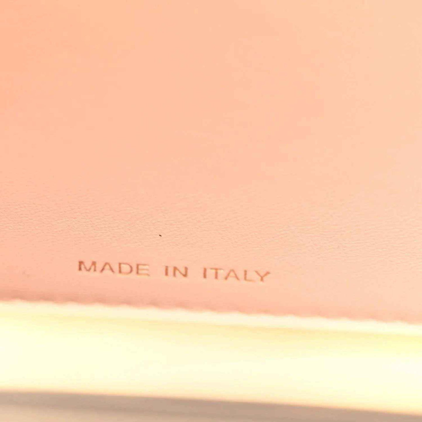 “MADE IN ITALY” stamped on light lining inside a black satchel
