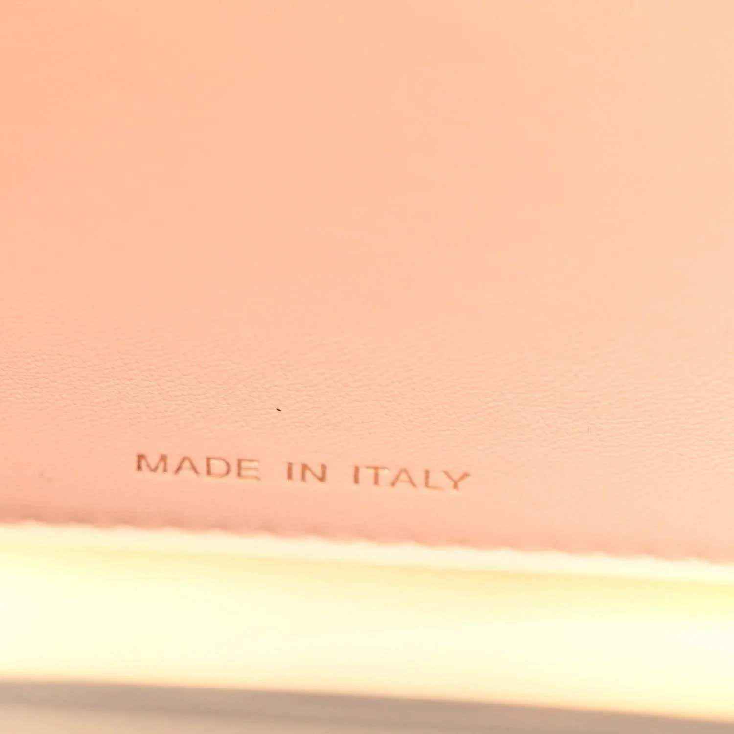 “MADE IN ITALY” stamped on light lining inside a black satchel