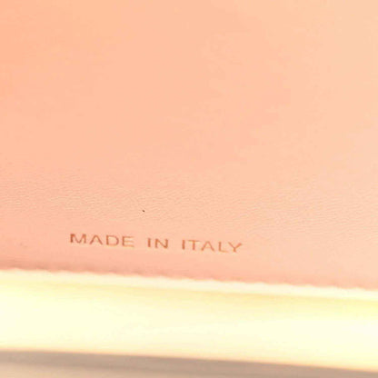 “MADE IN ITALY” stamped on light lining inside a black satchel