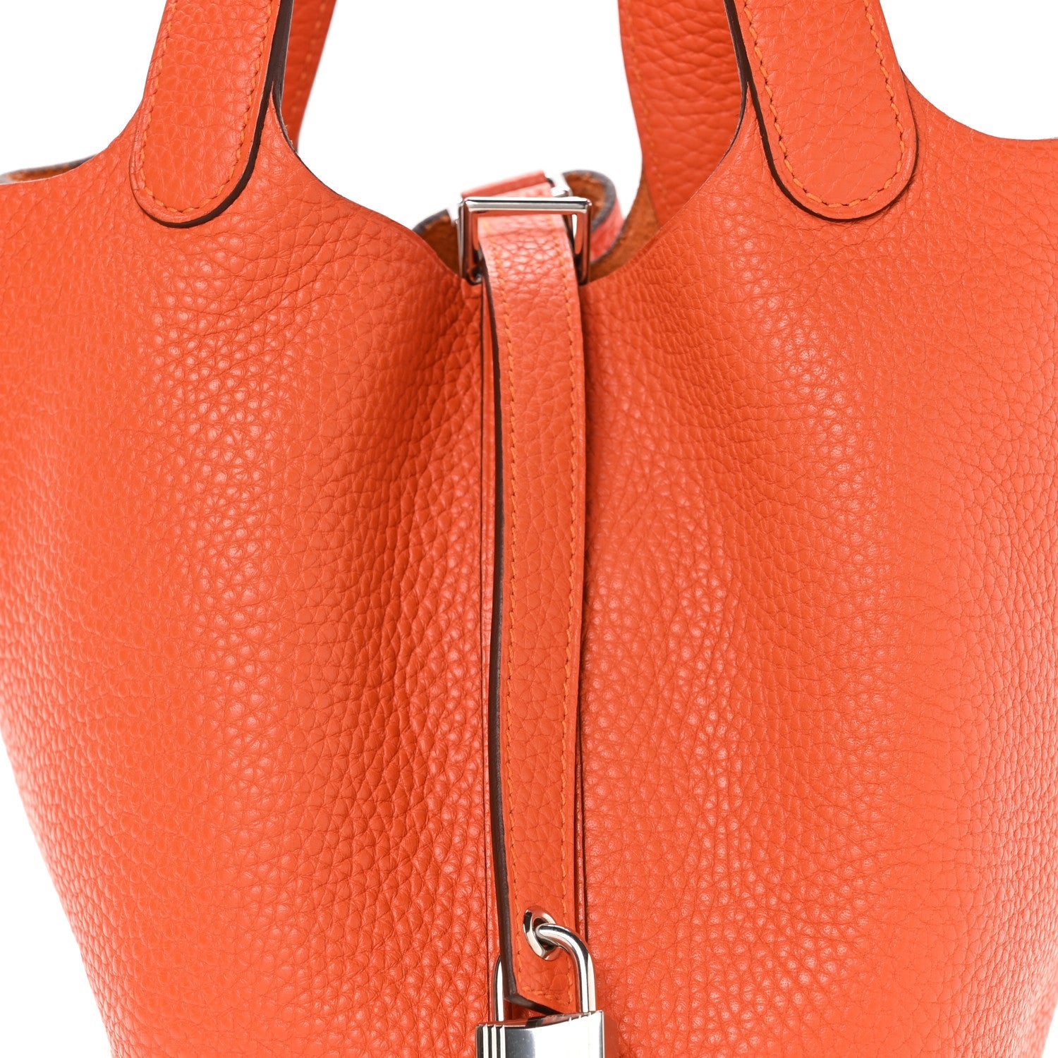 Orange leather handbag with top handle and metal clasp, side view