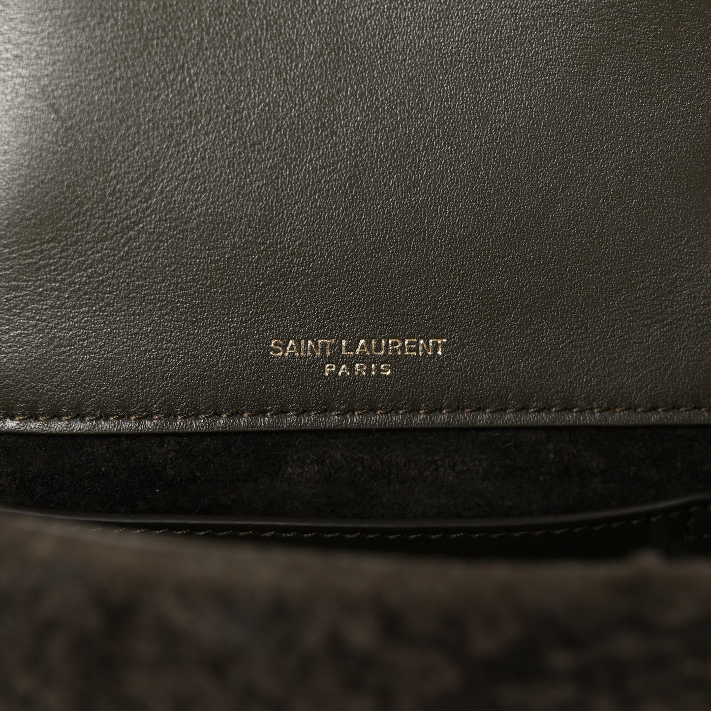 Leather interior panel with 'SAINT LAURENT PARIS' stamp on dark lining