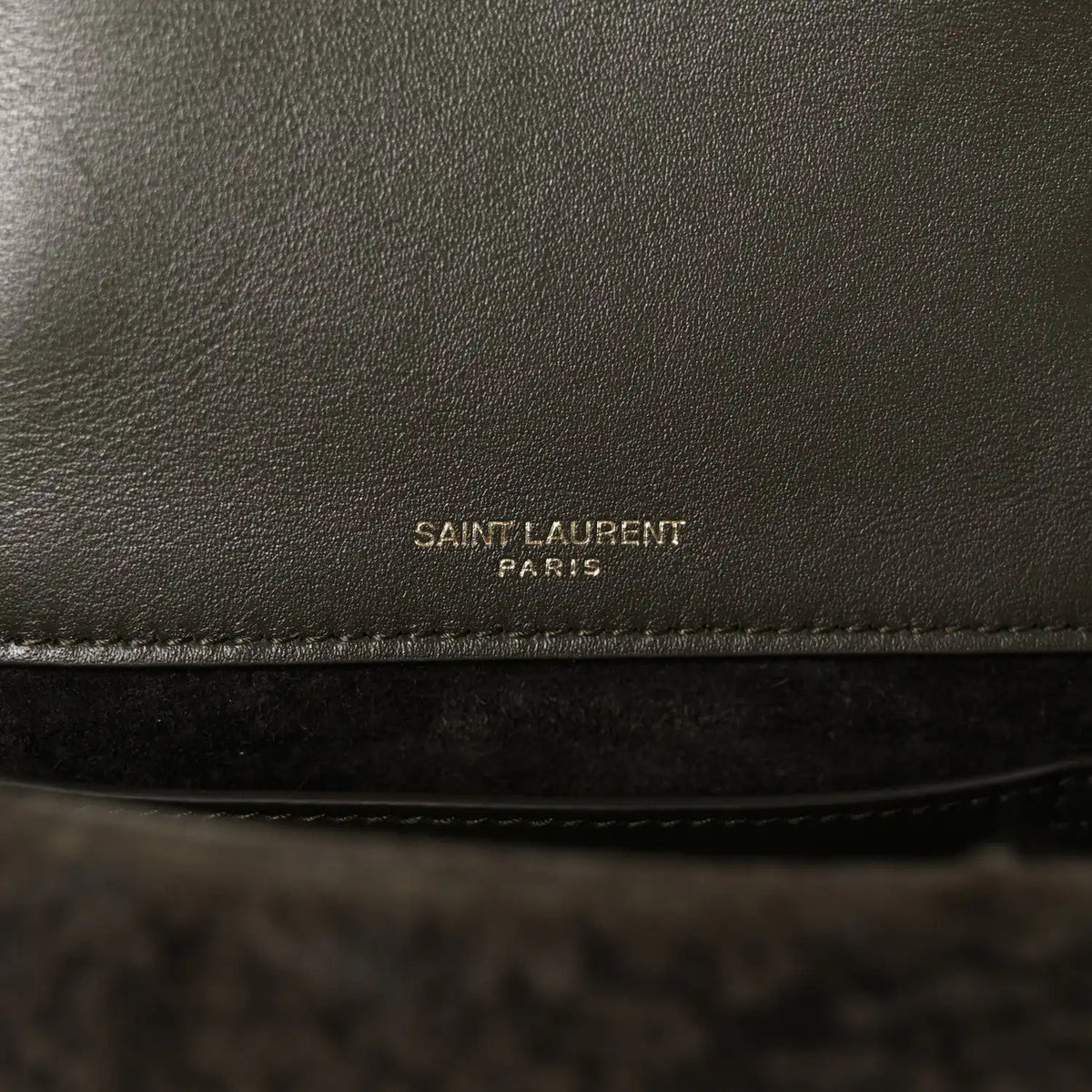 Leather interior panel with 'SAINT LAURENT PARIS' stamp on dark lining