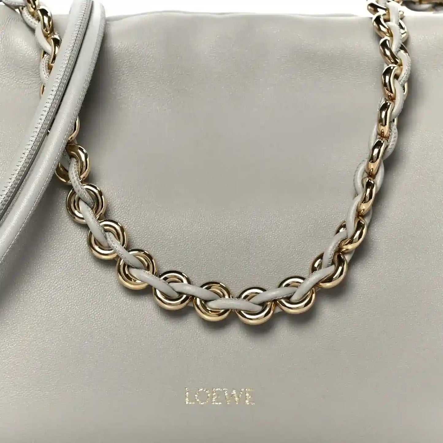 Loewe clutch chain strap detail with interlinked metal links on light grey leather