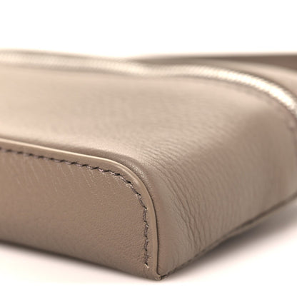 Bottom edge of a grained leather mini pouch with rounded corner seam