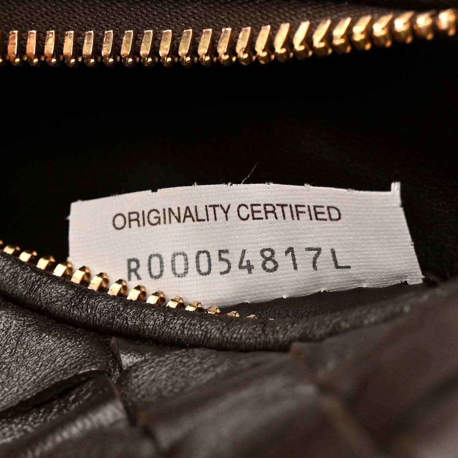 Interior label close-up reading "ORIGINALITY CERTIFIED" with code