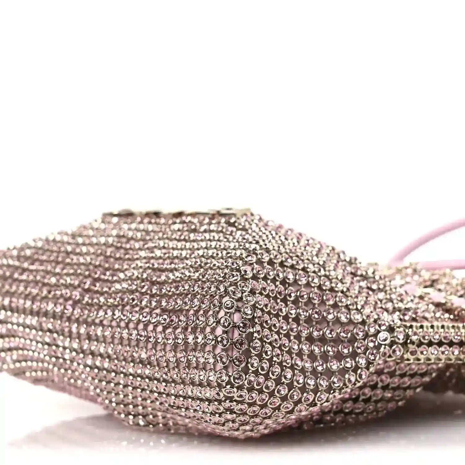 Chanel Mini 22 handbag close-up of pink metallic crystal mesh on rounded front side.