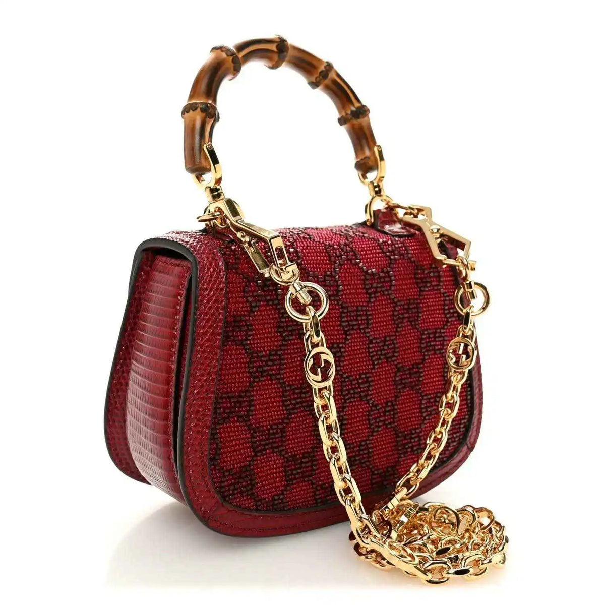 Red mini top-handle bag with textured pattern, gold chain strap, and front bar clasp hardware.