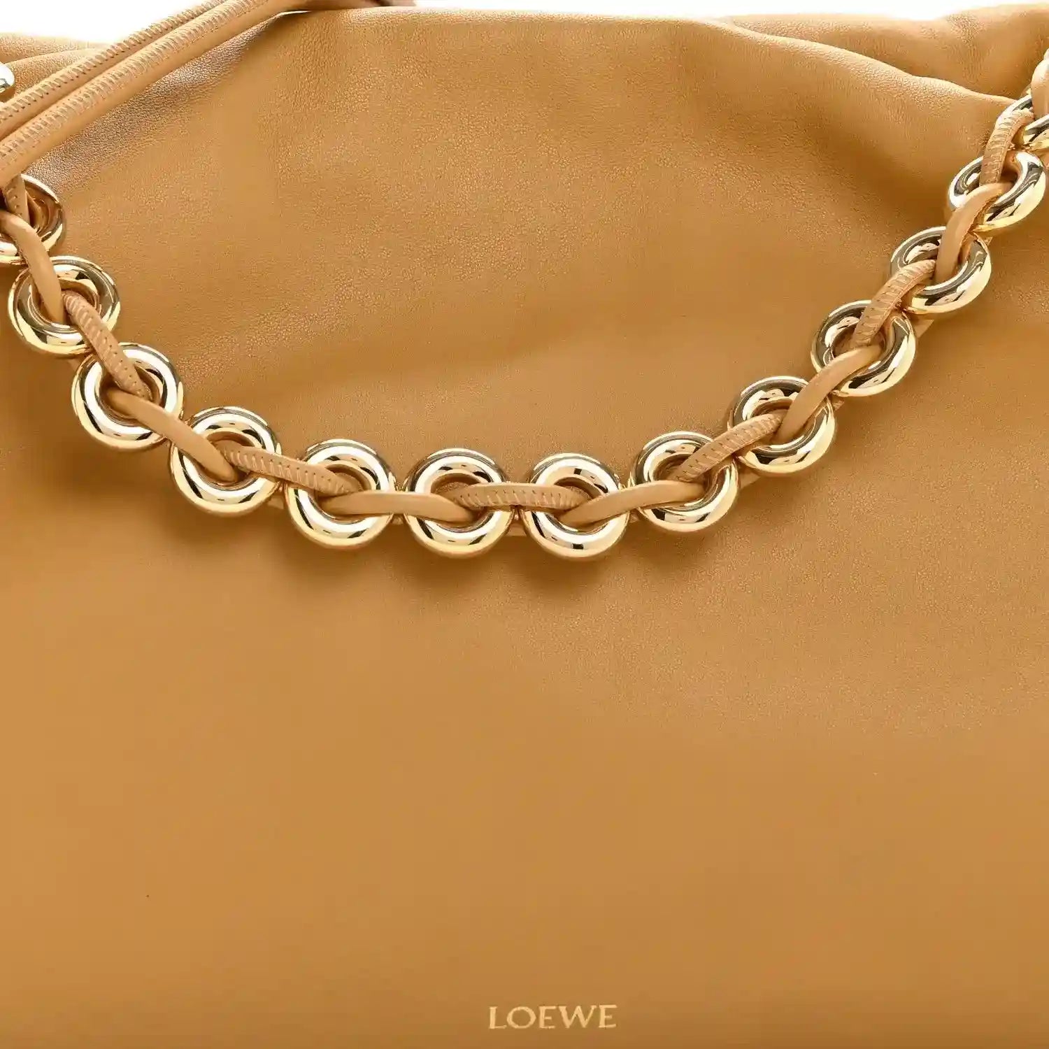 Tan leather clutch with braided chain strap and gold-tone metal links