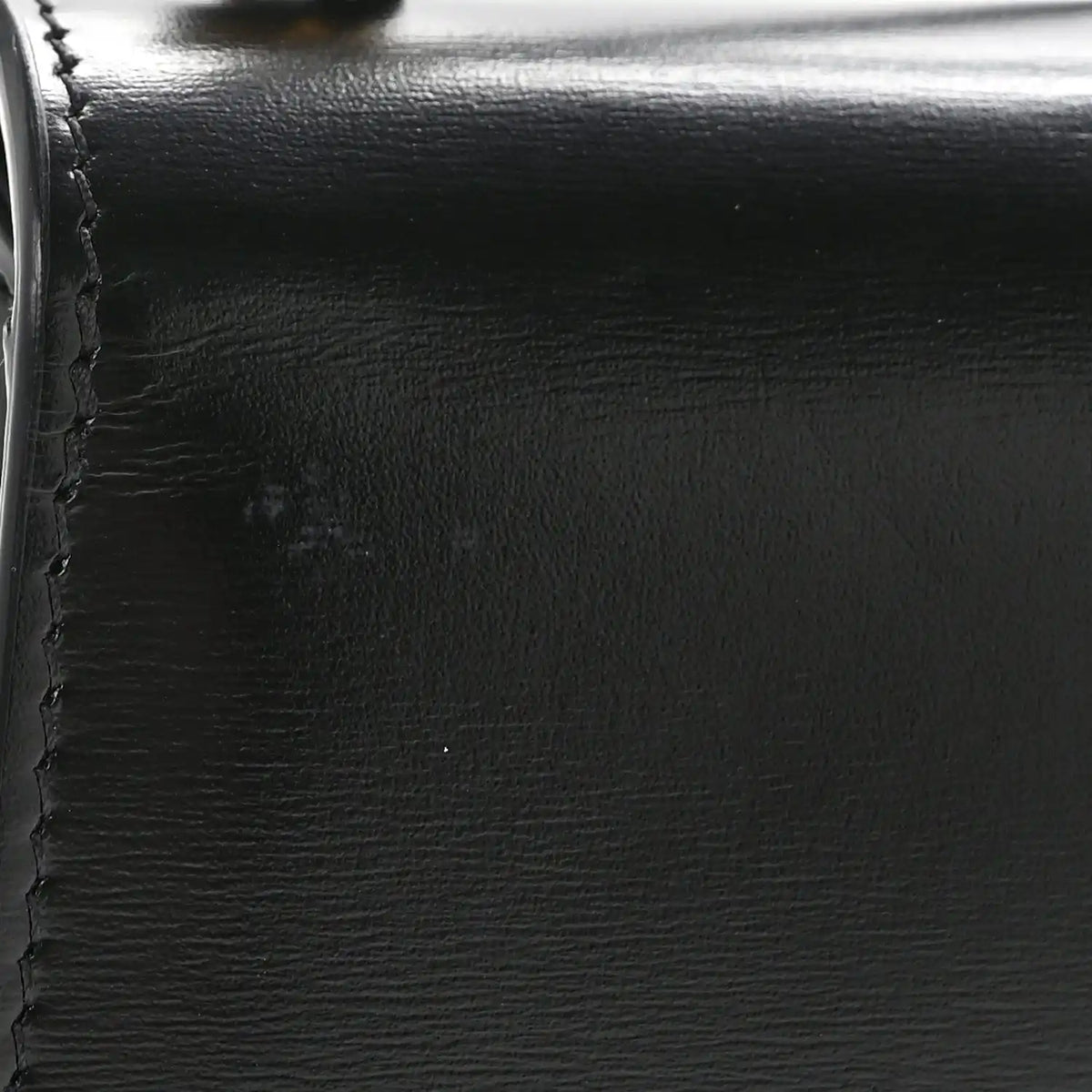 Black shiny calfskin with visible stitching and smooth edge close-up
