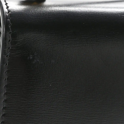 Black shiny calfskin with visible stitching and smooth edge close-up