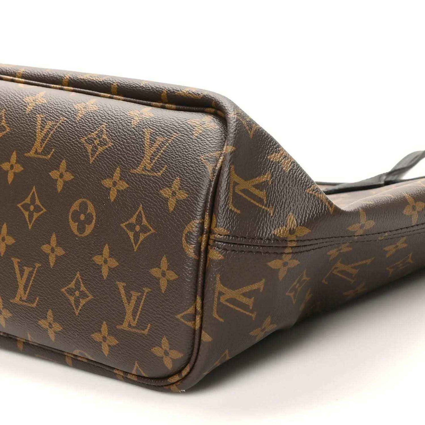 Monogram canvas tote with corner panel, zip trim, and shoulder strap