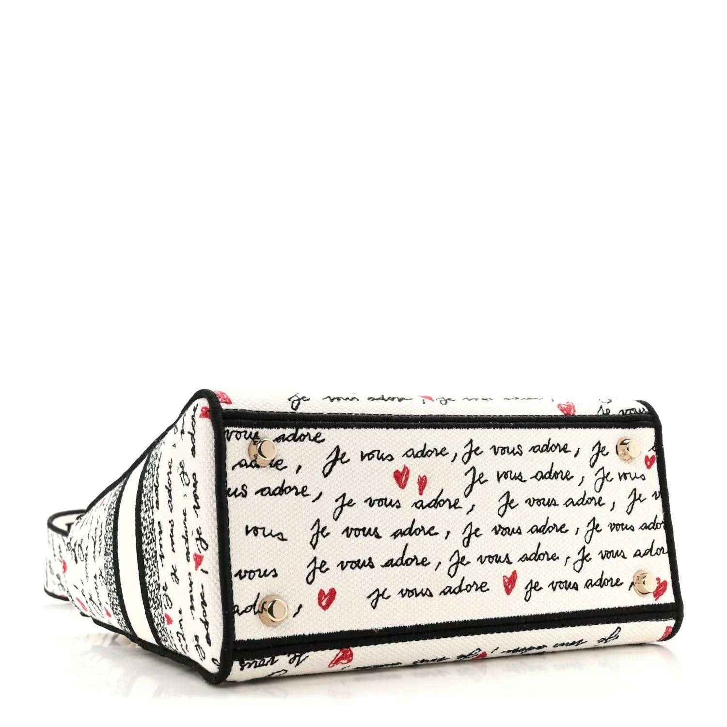 Christian Dior canvas handbag with “Je vous adore” print and black zipper top
