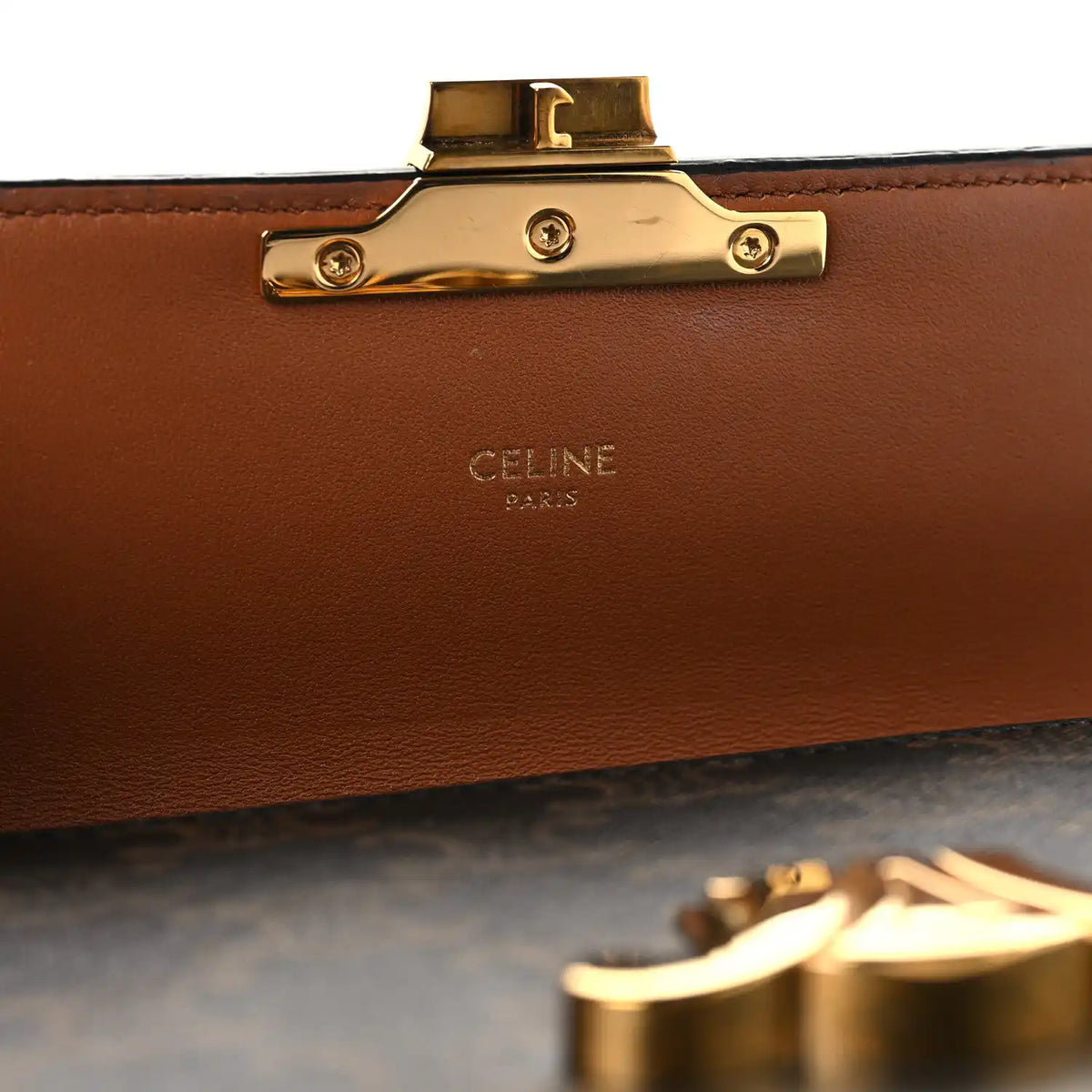 Celine bag clasp with gold hardware and brown leather lining panel