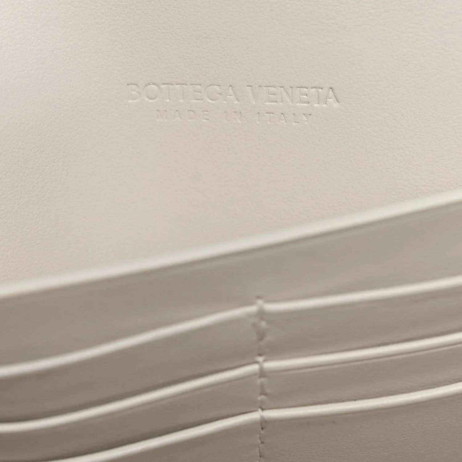 White Bottega Veneta leather clutch interior with embossed logo