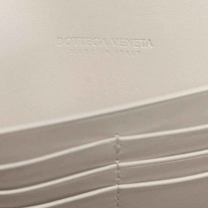 White Bottega Veneta leather clutch interior with embossed logo