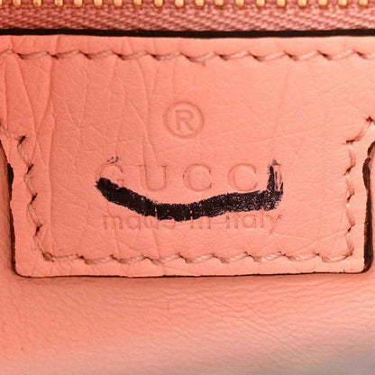 Gucci small hobo bag leather label close-up with embossed logo