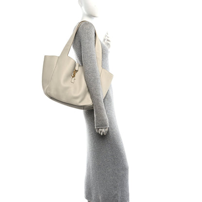 White grained leather tote bag with side profile and hanging scarf detail