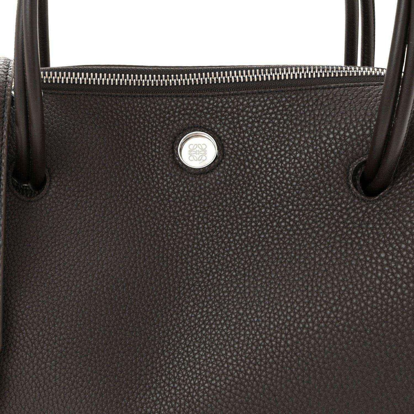 Top view of Loewe Madrid bag in dark grained leather with zipper and logo seal