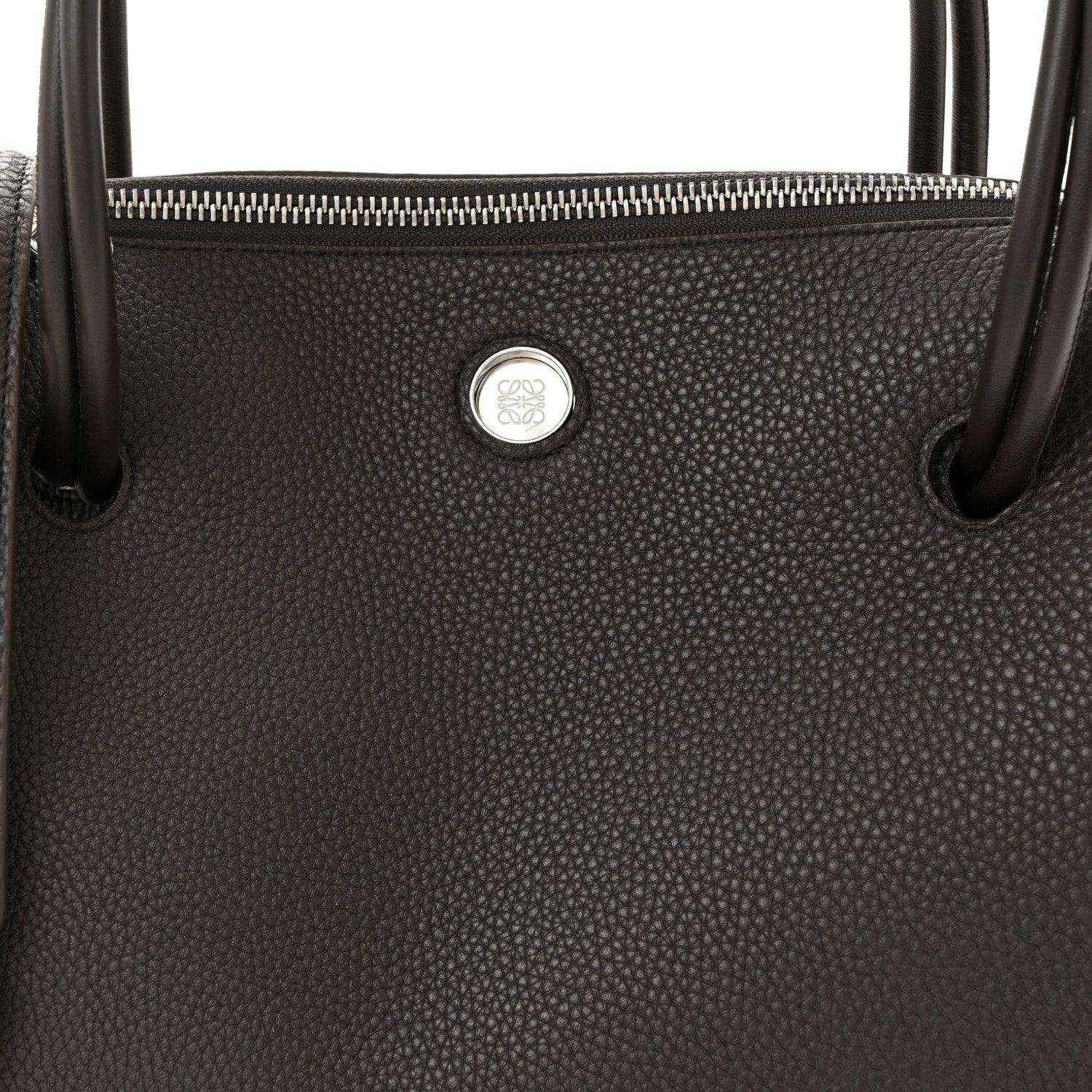 Top view of Loewe Madrid bag in dark grained leather with zipper and logo seal