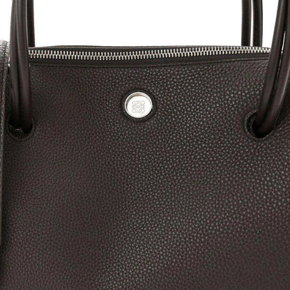 Top view of Loewe Madrid bag in dark grained leather with zipper and logo seal