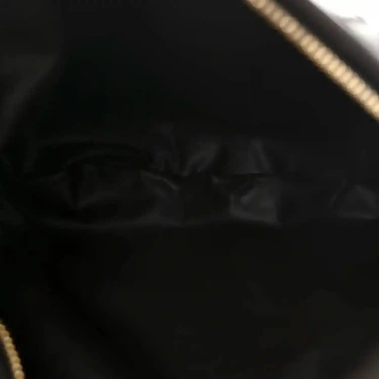 Hobo bag interior lining in dark leather with visible seam and zipper edge