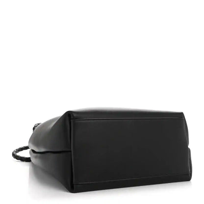 Black bucket bag with structured base and rectangular top frame