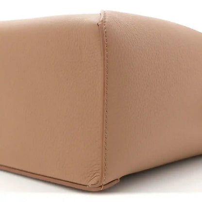 Toffee leather base edge with neat turn-stitching and grained texture