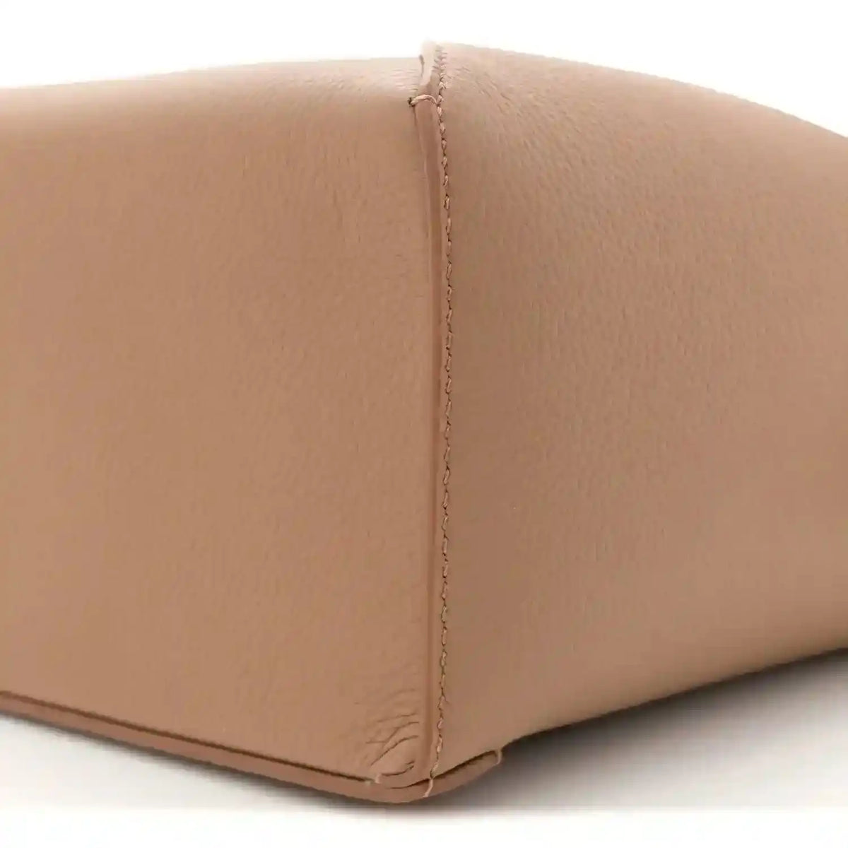 Toffee leather base edge with neat turn-stitching and grained texture