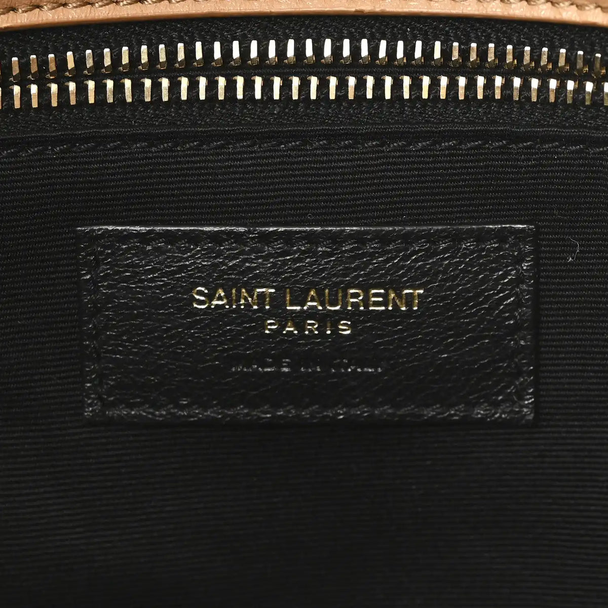 SAINT LAURENT shearling bag label on black fabric lining under zipper