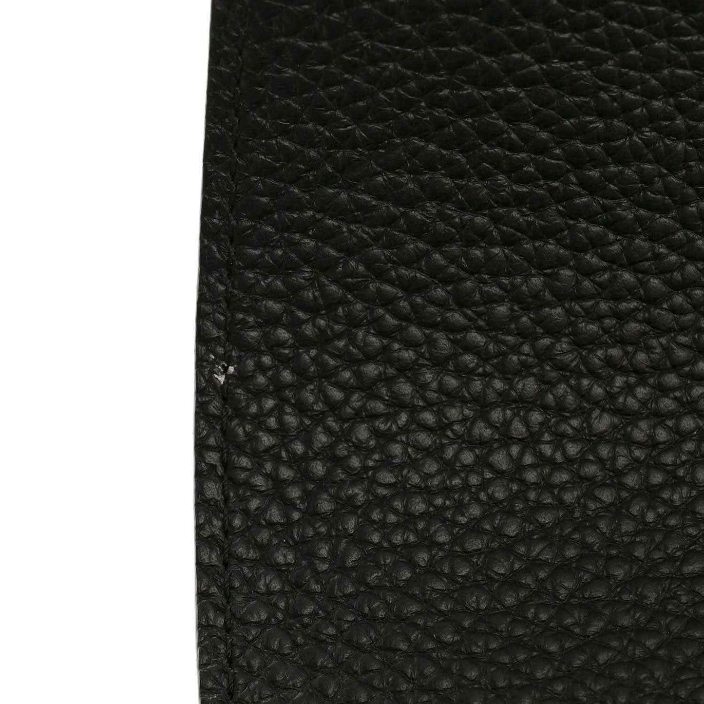 Black pebbled leather mini handbag texture close-up