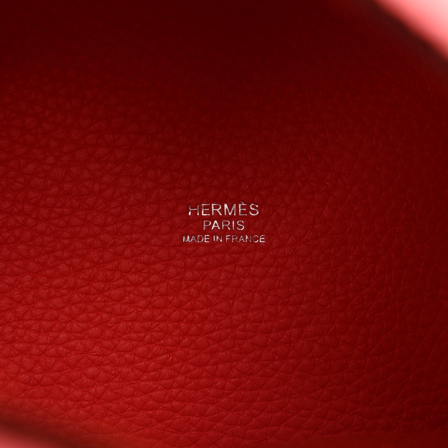 Red leather interior panel with embossed HERMES PARIS and MADE IN FRANCE