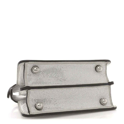 Silver crystal satchel front panel with snap buttons and leather strap