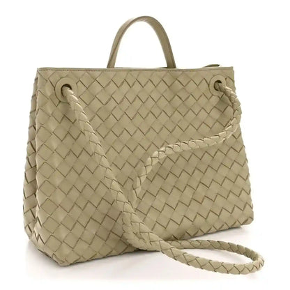 Woven leather tote with two top ties and braided shoulder strap, light tan