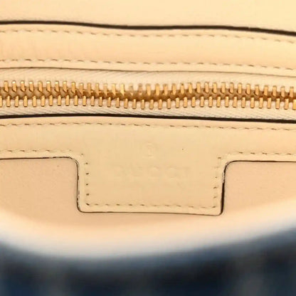 Beige leather interior edge with gold zipper and stitched trim