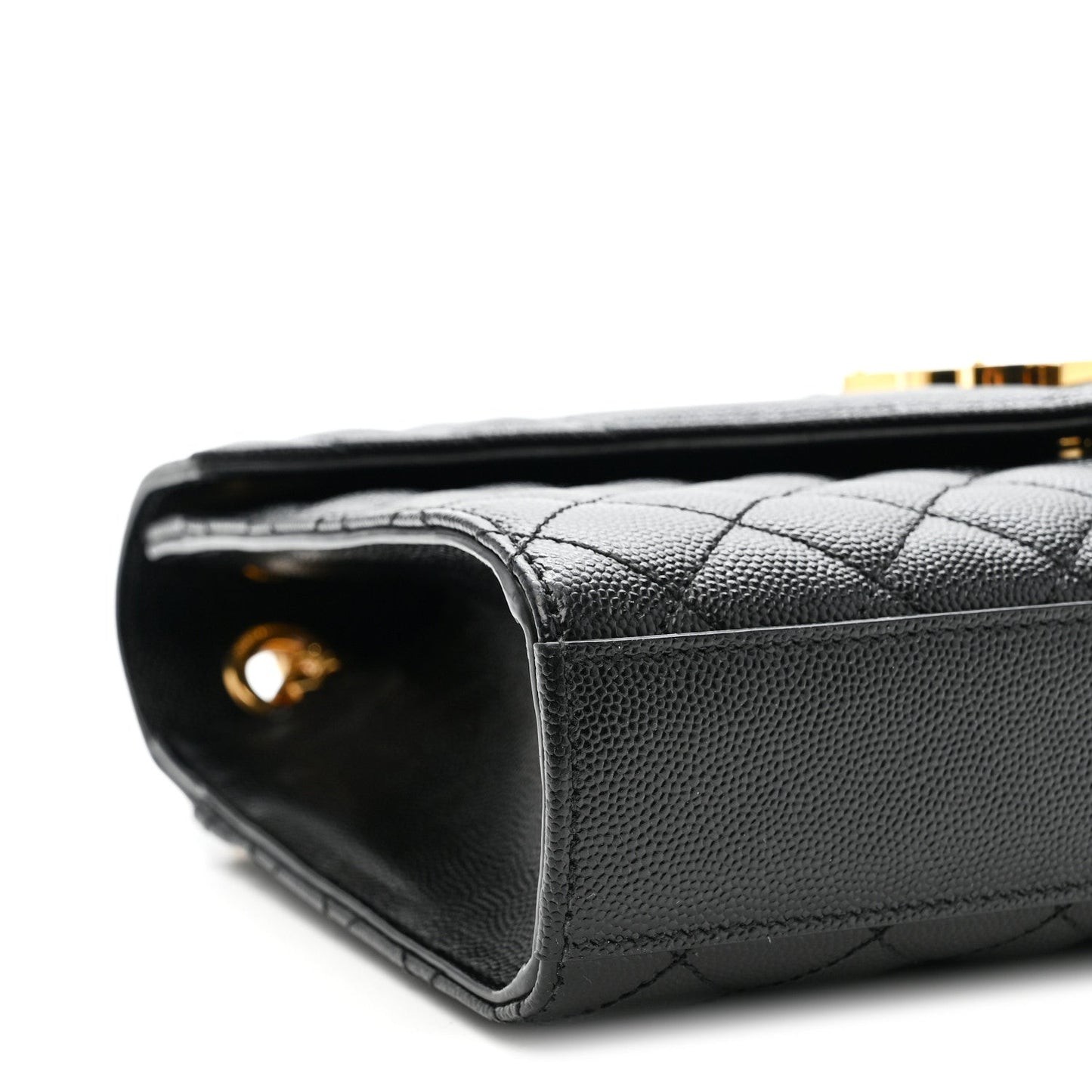 Black quilted satchel end view with gold chain connector and leather corner