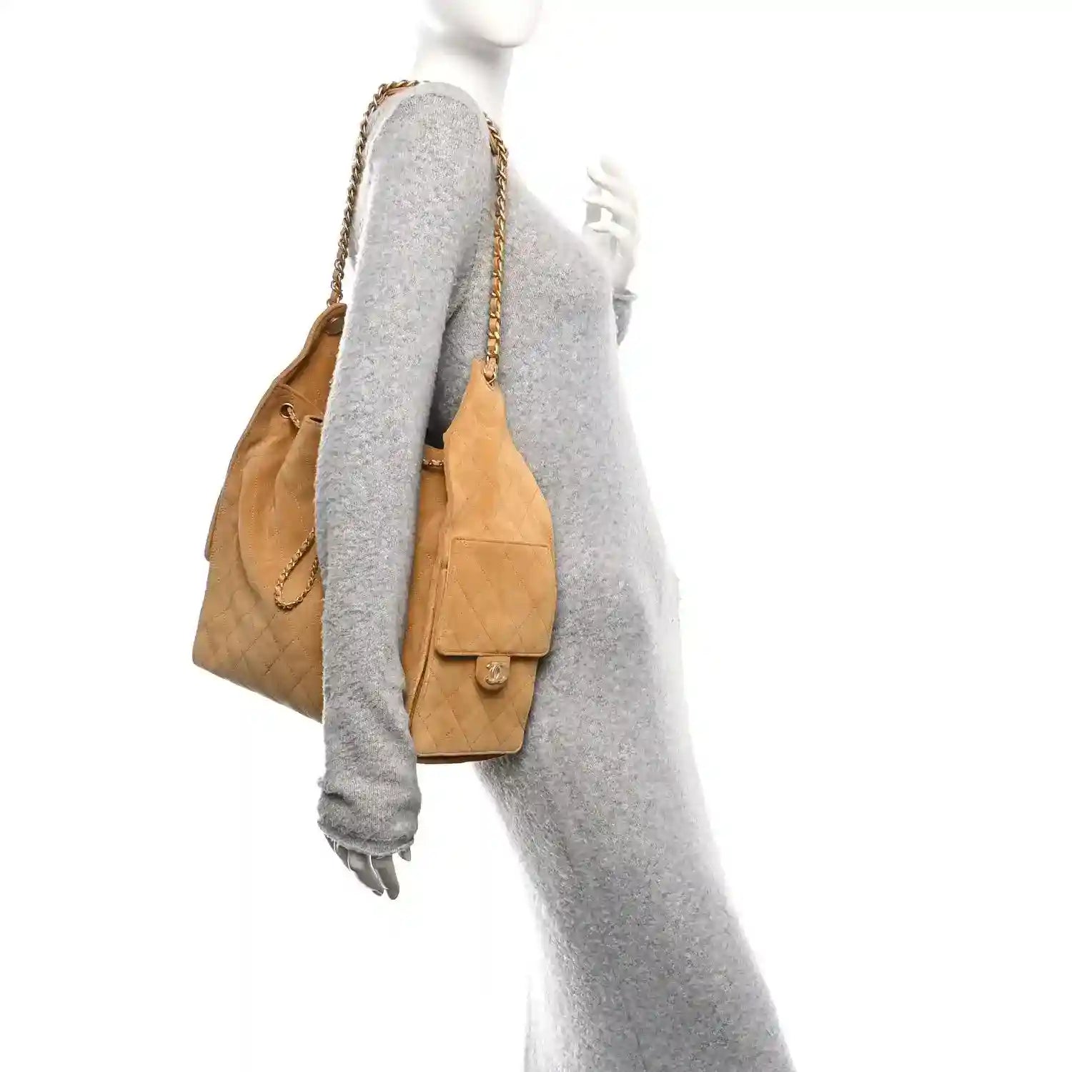 Chanel suede quilted medium handbag in classic beige worn on shoulder with flap pocket