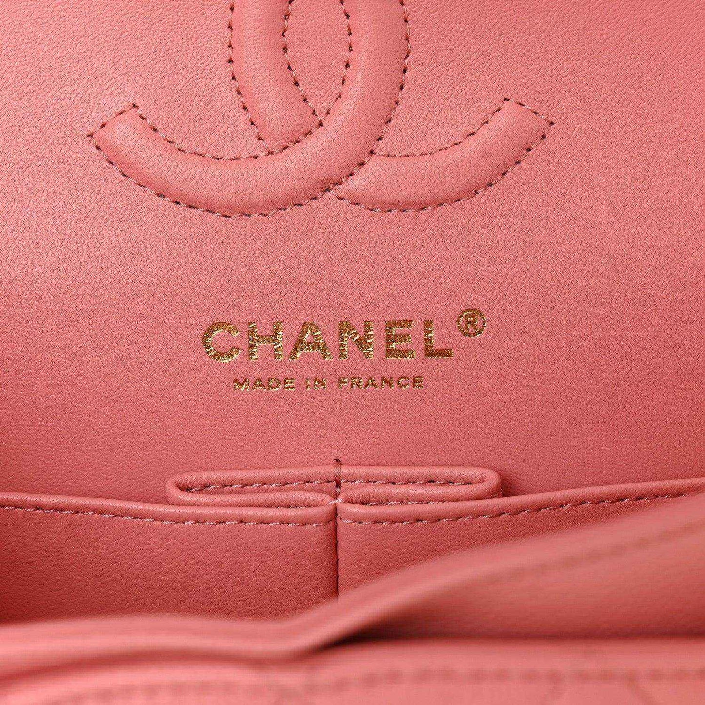 CHANEL logo and Made in France mark on light pink caviar-textured leather