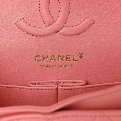 CHANEL logo and Made in France mark on light pink caviar-textured leather